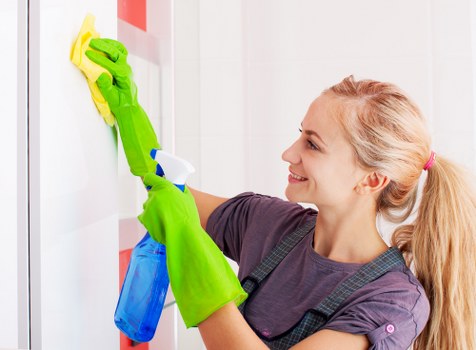Office cleaning team maintaining a bright modern workspace
