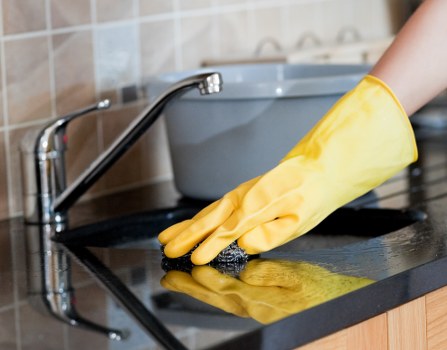 Oven cleaning in a modern kitchen with a freshly cleaned appliance