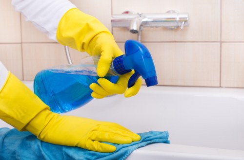 Cleaner performing a one off cleaning checklist in a bright apartment